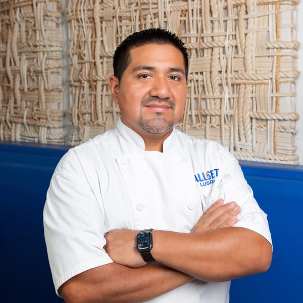 Chef Luis Ramirez of Fryer's Roadside in a white chef's coat with arms crossed.